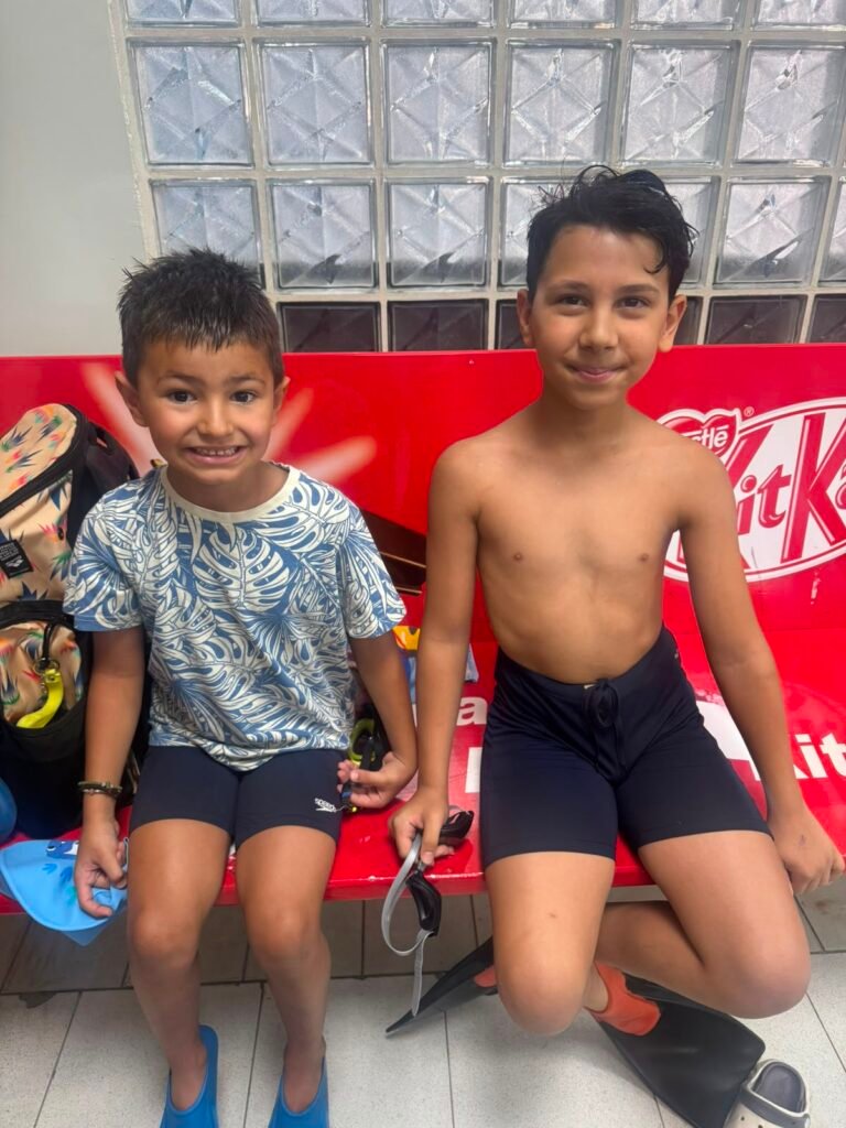 Two young swimmers preparing beside the pool during the championship.