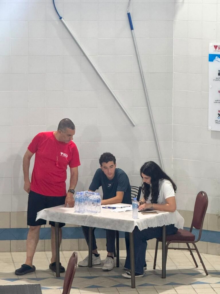 Championship officials working beside the swimming pool.