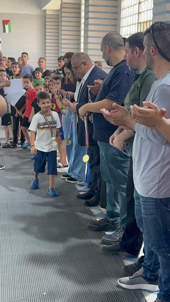 Young swimmer receiving recognition during the medal ceremony.